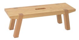 Large wooden footrest with simple, minimalist design. Rectangular shape with smooth, natural wood finish. Suitable for use as a stool or low table.