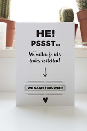 Scratch card with the text "Wij willen je iets leuks vertellen" (We want to tell you something nice) in a minimalist black and white design.