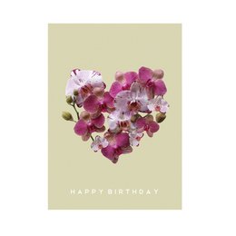 A postcard with a heart-shaped arrangement of pink and purple flowers against a light beige background, with the text "HAPPY BIRTHDAY" printed in gold.