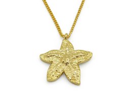 Gold-tone starfish pendant necklace with green accent stone, suitable for casual or formal wear.