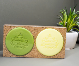 Lemon and eucalyptus scented soap bars on a cork holder. The soap bars have a round, disc-like shape and are made of natural ingredients.