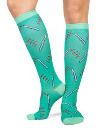Compression socks with a medical-themed pattern in shades of green. Designed to provide support and comfort during surgery or other medical procedures.