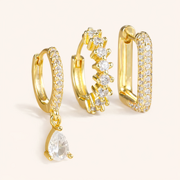 Gold statement earrings with cubic zirconia crystals, rectangular hoop design, elegant drop pendant style.