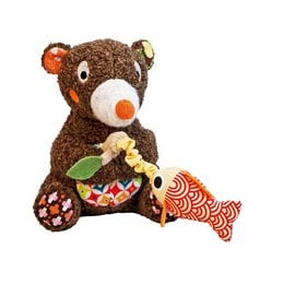 A plush brown bear toy with a colorful fish-shaped rattle attached to it. The bear has large eyes and a friendly expression, making it an appealing musical toy for babies and young children.
