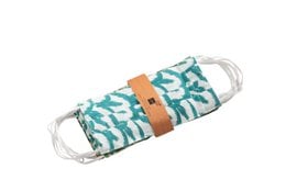 Reusable cotton face masks in various green and teal patterns, including polka dots, chevrons, and leaf designs.
