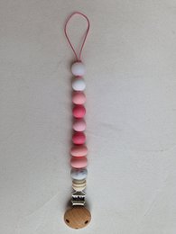 Pacifier clip with glow-in-the-dark white beads and pink gradient beads, featuring a metal charm.