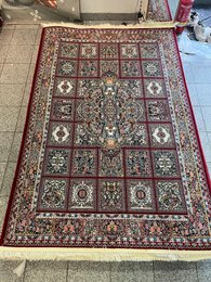 Large dark blue area rug with intricate floral and geometric patterns, suitable for living rooms or bedrooms.