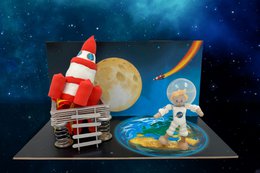 Craft package featuring astronaut figurines, rocket, and planets in a space-themed design. Suitable for arts and crafts projects.