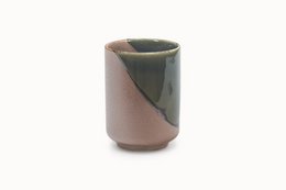 A ceramic cup with a two-tone color design, featuring a combination of light and dark shades.