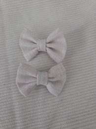 Two beige hair bows, each measuring 4cm in size, suitable for kids.
