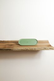 Rectangular green tray made of ceramic material with a simple, minimalist design suitable for decorative purposes.