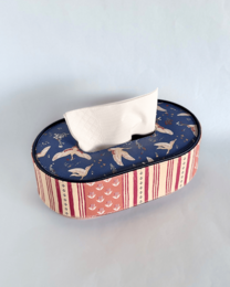 Navy blue vegan leather tissue box with gold airplanes, red striped sides, oval shape holder.