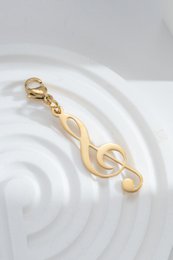 Charm clave de sol dorada en acero, clip musical, elegancia, pasión artística, chic