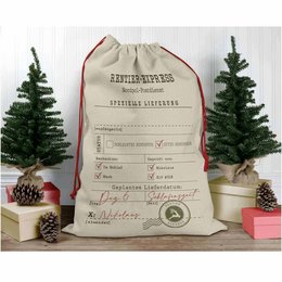 A large, white Santa gift bag with a printed "Reindeer Express" design. The bag has a drawstring closure and appears to be made of a durable, canvas-like material. The bag is shown in a festive holiday setting with small Christmas trees and other decorative elements.