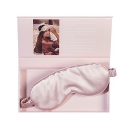 Luxury pink silk sleep mask with Beauty Pillow® branding. Soft, comfortable material for a restful sleep.