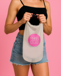  A waterproof and transparent dry bag with a pink trim, designed to carry towels or other items while traveling.