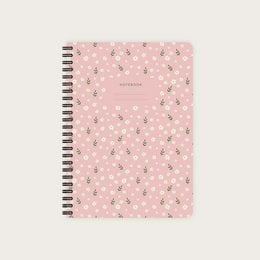 A pink spiral-bound notebook with a boho floral pattern featuring small white flowers. The notebook is available in various ruling styles including blank, grid, lined, and dot grid.