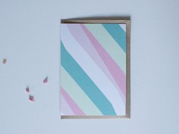 Colorful striped postcard with pastel shades of blue, pink, and white.