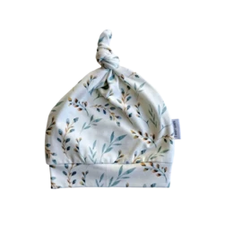 Soft, knot-tied baby hat in a floral print pattern. Made of breathable, stretchy cotton material suitable for newborns and infants up to 6 months old. Available in sizes 0-3 months and 3-6 months.