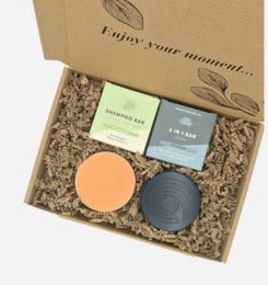Pampering gift set with bath bomb, soap, and candle in a gift box. Includes relaxing scents and natural ingredients for a spa-like experience.
