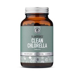 Clean chlorella tablets, green superfood supplement, detox wellness, dark amber glass bottle.