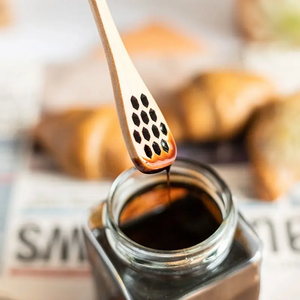 Wooden honey spoon with holes
