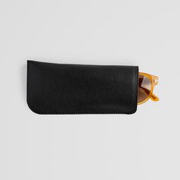 Minimalist black leather eyewear sleeve, available in black, brown, and grey. Protects sunglasses or eyeglasses.