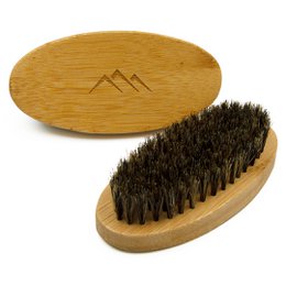 Oval wooden beard brush with natural bristles for grooming and styling facial hair.