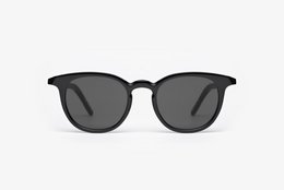 Black round sunglasses with a sleek, modern design.