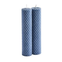 Beeswax candles in a classic cylindrical shape with a textured honeycomb pattern in a deep blue color.