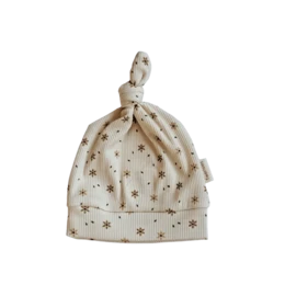 A soft, knitted baby hat in a neutral color with a subtle star pattern. The hat is suitable for infants aged 0-6 months.