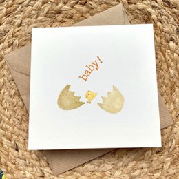 Adorable baby chick hatching from egg, gold foil design, greeting card for new baby.