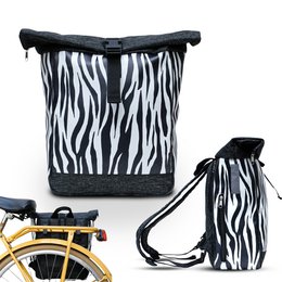 A black and white zebra-patterned backpack/bike bag with a drawstring closure and adjustable straps.