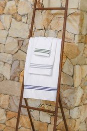 A soft, absorbent guest towel made from 100% combed cotton in navy, green, or gray colors.