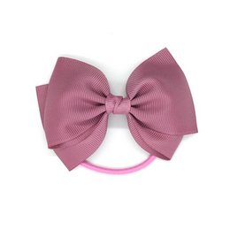 Rosy mauve medium bow elastic hair tie with a soft, textured fabric bow.