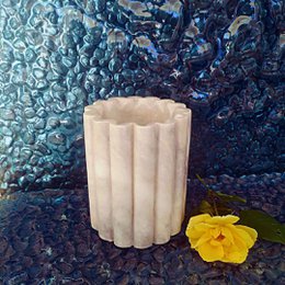  Marble wine cooler with a cylindrical shape and fluted design, suitable for chilling and serving wine.