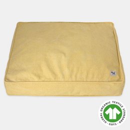 Sustainable, breathable, and machine-washable dog and cat bed cover made of 100% organic cotton canvas in a pale mustard or yellow color. Available in round or rectangular shapes in various sizes.