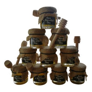 Honigglas mit Löffel und Sackleinen