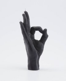 Black candle in an okay hand gesture shape. Minimalist, modern design.