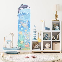 Underwater-themed wall sticker featuring colorful marine life including a dolphin, fish, and seashells. Suitable for decorating a child's bedroom or playroom.