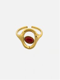  Oval gold-toned ring with a red gemstone, a statement piece for fashion-forward accessorizing.