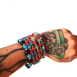 Colorful beaded elastic bracelet with red, blue, black, and natural stone beads.