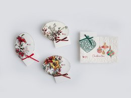 A collection of Christmas greeting cards featuring festive designs with ornaments, wreaths, and holiday imagery.