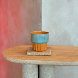  Stoneware cupcake cup in amber sky color with a textured, ribbed design.