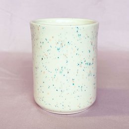 Speckled ceramic coffee mug with a celebratory design, suitable for everyday use or gifting.