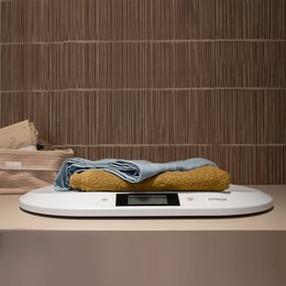 White digital baby scale for weighing infants and toddlers.