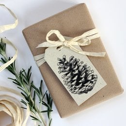Grass paper gift tags with pine cone design, natural and rustic style.