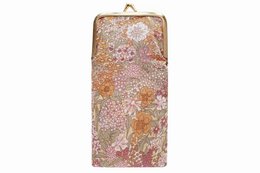 A green olive-colored glasses case with a floral pattern in shades of red, yellow, and green.