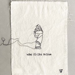 A hand-drawn illustration of a person wearing a winter hat and scarf, with the text "baby it's cold" below. The image appears to be a poster or wall art.