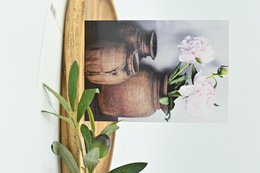 Vintage-style postcard with pink peonies in rustic ceramic vases.